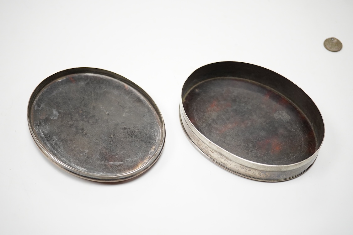 A 19th century white metal mounted tortoiseshell oval snuff box, with inset oval white metal plaque engraved with family crest, unmarked, 10.1cm.